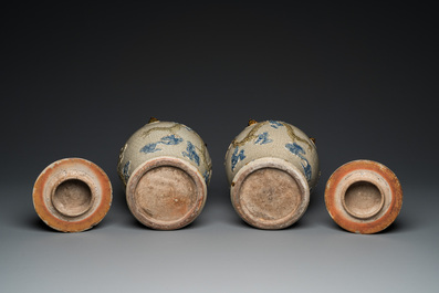 A pair of Vietnamese Bat Trang stoneware 'dragon' vases and covers, 19th C.