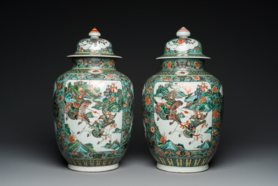 A pair of  Chinese famille verte vases and covers, 19th C.