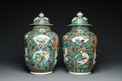 A pair of  Chinese famille verte vases and covers, 19th C.