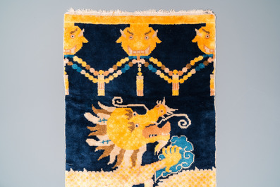 A Chinese silk 'dragons' carpet, 19th C.