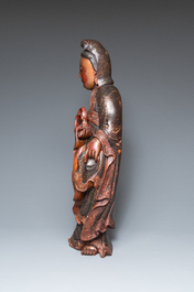 A large Chinese gilt-lacquered wood figure of Guanyin on a carved wooden stand, 17th C.