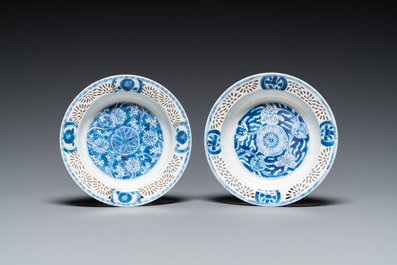 A pair of Chinese blue and white reticulated double-walled cups and saucers, Kangxi