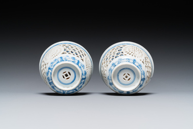 A pair of Chinese blue and white reticulated double-walled cups and saucers, Kangxi