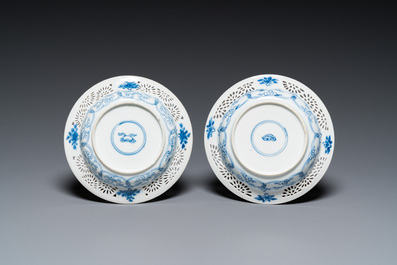 A pair of Chinese blue and white reticulated double-walled cups and saucers, Kangxi