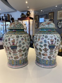 A pair of Chinese famille rose 'antiquities' vases and covers, 19th C.