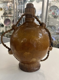 Two German stoneware bellarmine jugs and a pilgrim's flask, 17th C.