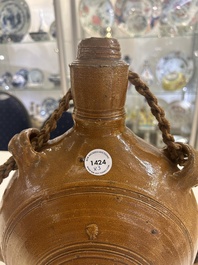 Two German stoneware bellarmine jugs and a pilgrim's flask, 17th C.