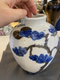 A pair of Chinese blue, white and copper-red vases, a blue and white covered vase and a Canton famille rose box and cover, 19/20th C.