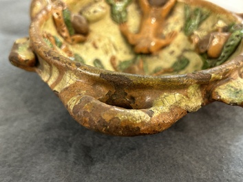 A slip-decorated three-handled earthenware bowl, probably Germany, 16/17th C.