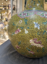 A large Chinese famille rose yellow-ground bottle vase, Qianlong mark, 19th C.