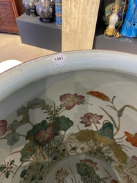 A large Chinese famille rose fish bowl on wooden stand, 19th C.