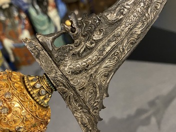 An Indonesian 'kris' or 'keris' dagger in polished Javanese wood with gilt copper and precious stones, 19th C.