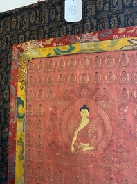 A red-ground thangka depicting the Medicine Buddha or Bhaishajyaguru surrounded by Shakyamuni Buddhas, Tibet or Nepal, 19/20th C.