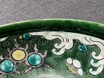 A Chinese verte biscuit 'galloping horses' bowl, Qing