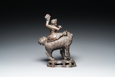 Een Chinese bronzen wierookbrander in de vorm van een Luohan op een boeddhistische leeuw, late Ming/vroege Qing