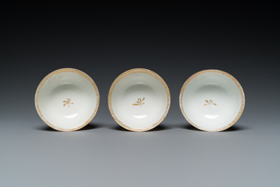 Three Chinese famille rose 'horserider' cups and saucers with the matching tea caddy, Yongzheng/Qianlong