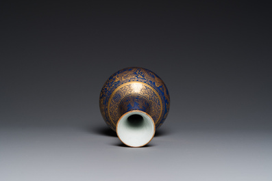 A Chinese monochrome blue gilt-decorated 'dragons' bottle vase, Qianlong mark, 19th C.