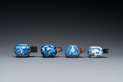 Four Chinese blue, white and copper-red bird feeders, 19th C.