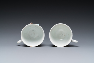 A pair of Chinese famille rose relief-decorated cups and saucers, Yongzheng