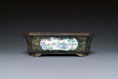 A Chinese Canton enamel gilt-decorated dark-green-ground jardini&egrave;re with four inserted plaques, Qianlong/Jiaqing