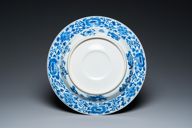 A large Chinese blue and white dish with raised central medallion, Kangxi