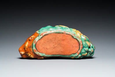 A Chinese sancai-glazed 'three lions' pillow or neck rest, Ming