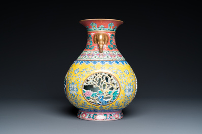 A Chinese reticulated and revolving famille rose vase consisting of two parts, Qianlong mark, 20th C.