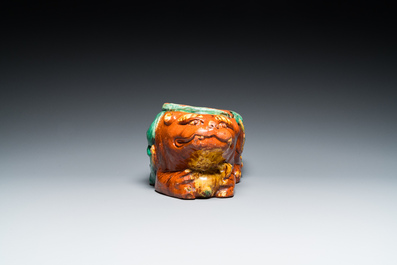 A Chinese sancai-glazed 'three lions' pillow or neck rest, Ming