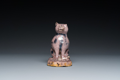 A manganese faience model of a cat, probably northern France, dated 1709