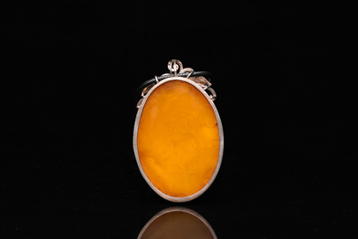 A Chinese silver and amber pendant, 20th C.