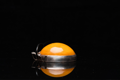 A Chinese silver and amber pendant, 20th C.