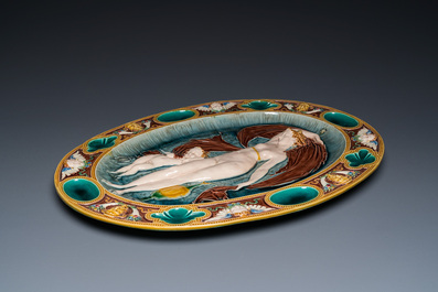 An oval Mintons majolica dish with a goddess with putto, England, year mark 1874