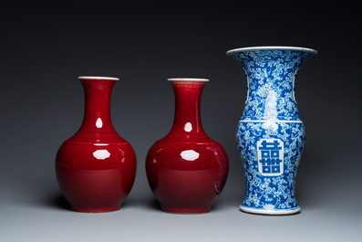A Chinese blue and white 'Shou' vase with butterflies and a pair of sang-de-boeuf-glazed bottle vases, 19/20th C.