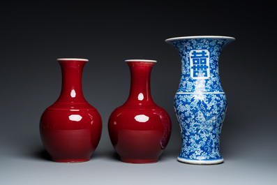 A Chinese blue and white 'Shou' vase with butterflies and a pair of sang-de-boeuf-glazed bottle vases, 19/20th C.