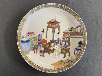 A fine Chinese famille rose eggshell porcelain plate with a boy and two governesses in an interior, Yongzheng