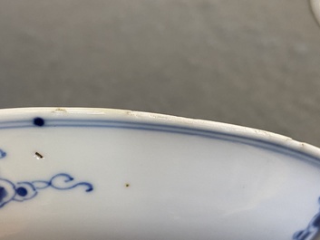 A pair of Chinese blue and white 'carps' cups and saucers, Kangxi