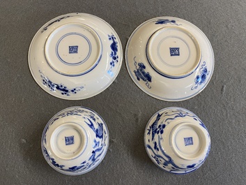 A pair of Chinese blue and white 'carps' cups and saucers, Kangxi