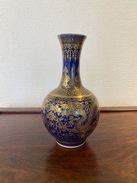 A Chinese monochrome blue gilt-decorated 'dragons' bottle vase, Qianlong mark, 19th C.