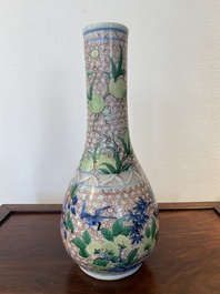 A Chinese wucai bottle vase with birds surrounded by fruits and foliage, Transitional period