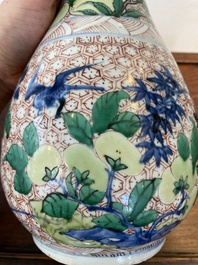 A Chinese wucai bottle vase with birds surrounded by fruits and foliage, Transitional period
