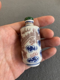 A Chinese blue, white and copper-red 'dragon' snuff bottle, Yongzheng mark, 19th C.