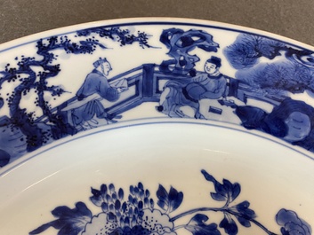 A large Chinese blue and white dish with raised central medallion, Kangxi