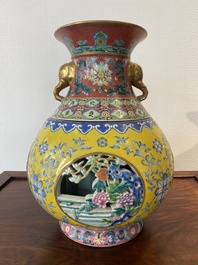 A Chinese reticulated and revolving famille rose vase consisting of two parts, Qianlong mark, 20th C.