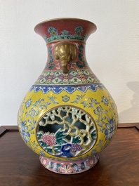 A Chinese reticulated and revolving famille rose vase consisting of two parts, Qianlong mark, 20th C.