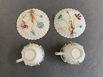 A pair of Chinese famille rose relief-decorated cups and saucers, Yongzheng