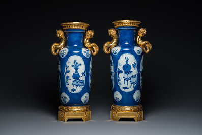 A pair of Chinese blue, white and copper-red powder blue-ground rouleau vases with fine gilt bronze mounts, Kangxi and 19th C.