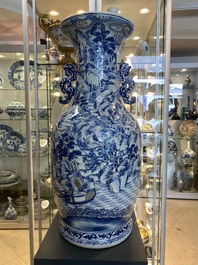 A large Chinese blue, white and copper-red vase with a mountainous river landscape, 19th C.