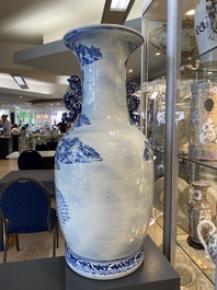 A large Chinese blue, white and copper-red vase with a mountainous river landscape, 19th C.