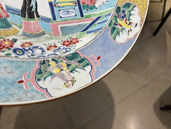 A large Chinese famille rose dish with a temple scene and eight immortals on the rim, Yongzheng