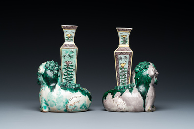A pair of Chinese verte biscuit vases resting on Buddhist lions, Kangxi